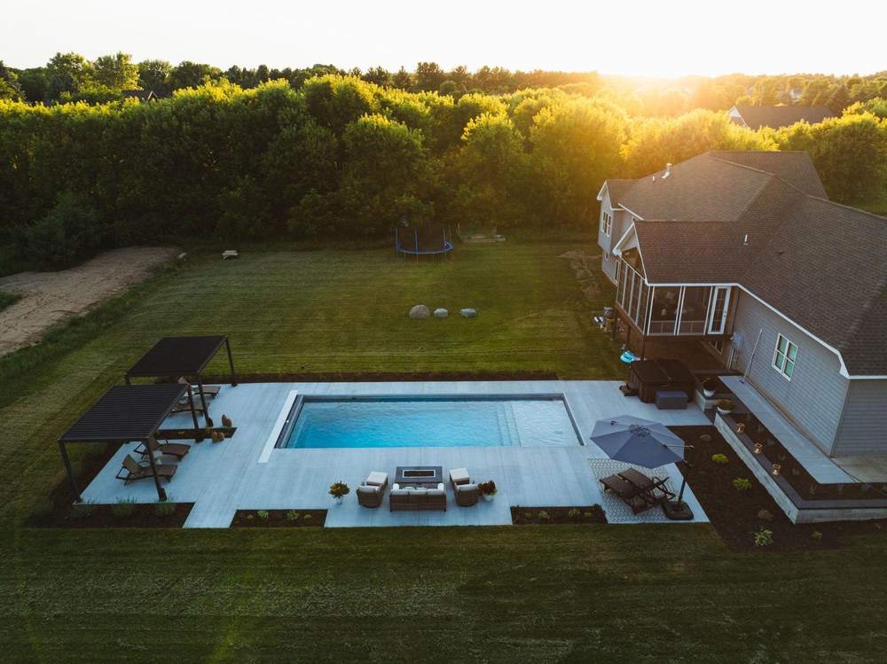 Aerial view of a Schifsky-built pool and patio at sunset